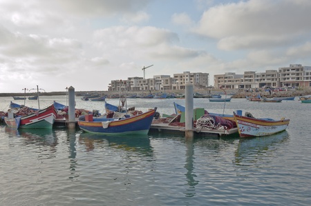 On foreground, colored barques on the Bouregreg river  Behind other barques and  new buildings -...