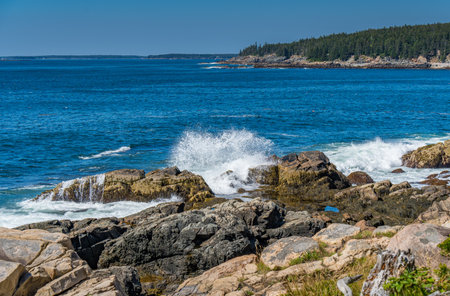Waves coming in and crashing into rocky coast at Acadia in Bar Harbor Maineの写真素材