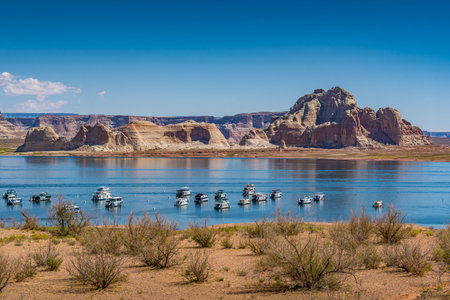 A view of house boats parked on Lake Powell in Glen Canyon near Page Arizonaの写真素材