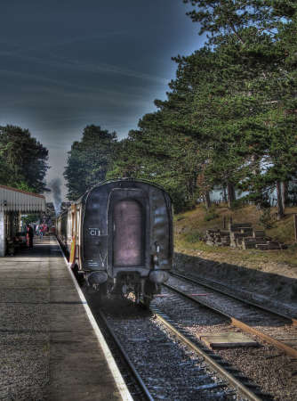 Abandoned train at the railway station with a dark sky.