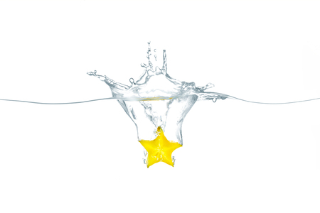 Splash Star fruit yellow isolated on white backgroundの写真素材