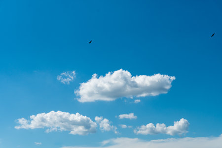Blue sky background with beautiful cloudsの写真素材