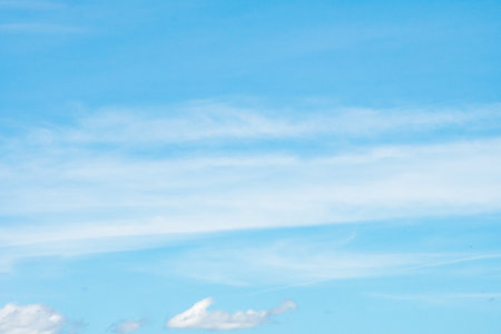 Blue sky background with beautiful cloudsの写真素材