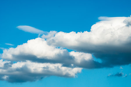 Blue sky background with beautiful cloudsの写真素材