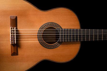 Classical guitar on black background. Acoustic guitar concept.Perfect for flyer, card, poster or...