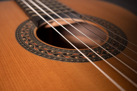 Classical guitar on black background. Acoustic guitar concept.Perfect for flyer, card, poster or wallpaperの写真素材