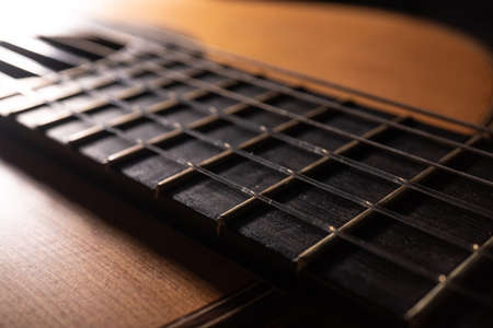Classical guitar on black background. Acoustic guitar concept.Perfect for flyer, card, poster or...