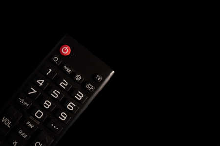 TV power button on the remote control on black background.の写真素材