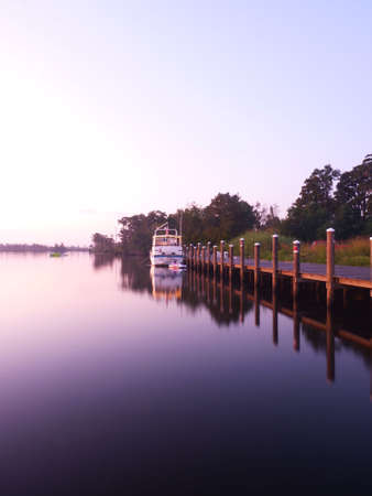 a boat docked along the riverのeditorial素材