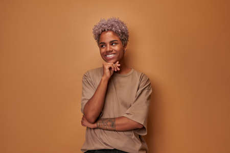 African woman with perfect clean freckles skin looks and smiles at cameraの写真素材