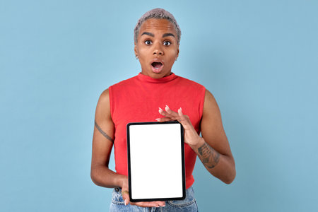 Young African American woman shows electronic tablet with white screen