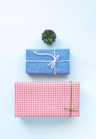 Christmas gift boxes as Christmas tree. Overhead view. On the top of imagined Christmas tree is a green bump.の写真素材