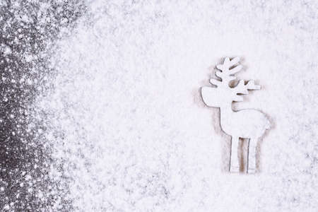 Christmas and holidays background. Silhouette of little deer in christmas snowfall. New Year is coming concept. Copy space.の写真素材
