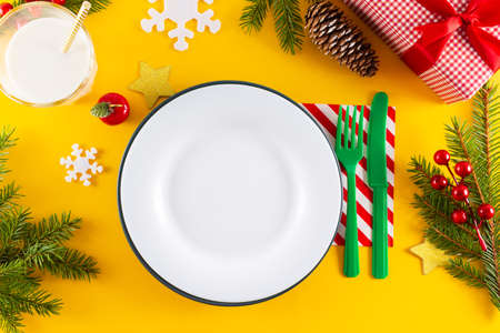 New year's table setting. Mock up white plate, knife, fork, glass with milk and christmas...