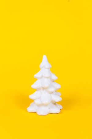 Christmas minimal concept. White plastic fir on yellow background.の写真素材