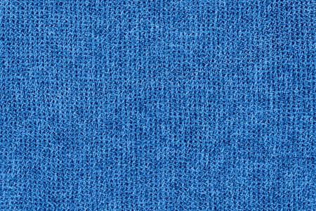 Abstract blue knitted background. Wool fabric texture.
