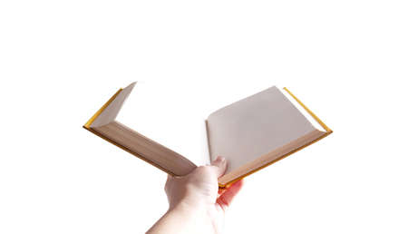 Female hand holding opened book on white background. Book in yellow hard book cover with blank...