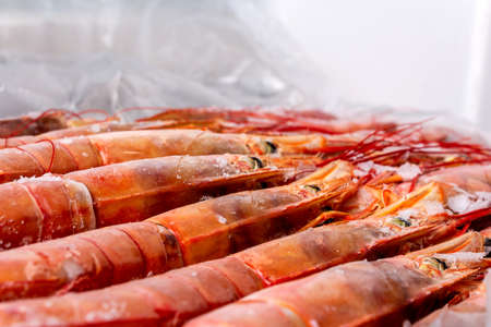 Amazing fresh large frozen shrimps. Pink fresh uncooked shrimps. Close-up. Delivery of frozen...