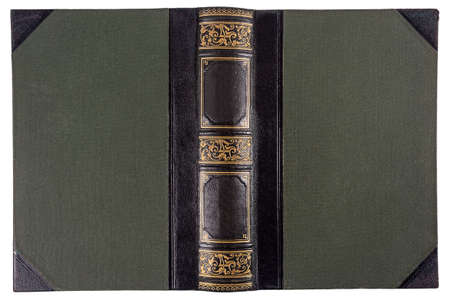 Old opened book's cover isolated on white. Textile binding with leather accents and gold embossed pattern.の写真素材