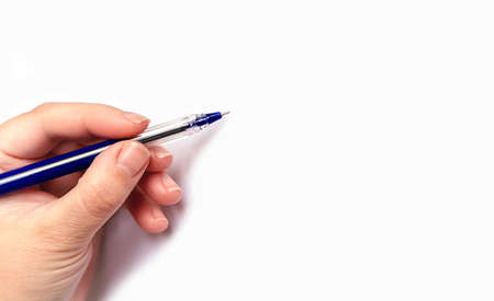 Large banner with caucasian hand writing blue pen on light background using the left hand. Copy space. Education concept.の写真素材