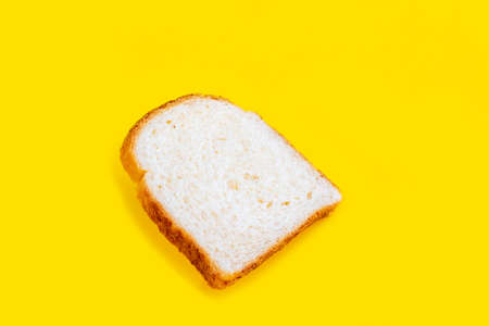 Close up photo of fresh baked toast bread on yellow background. Top view. Bread for breakfast.の写真素材