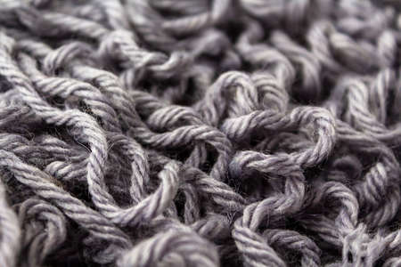 Thick dense woolen threads gray color for knitting. Top view. Wool texture background.の写真素材
