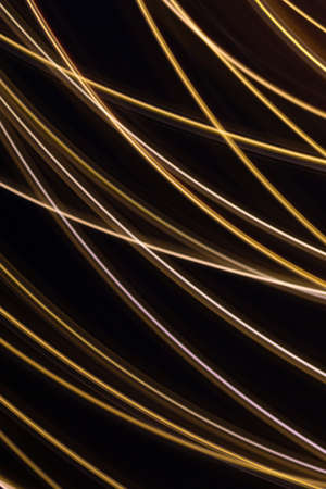 Festive black background with blurred gold lines. Christmas backdrop with glowing white and gold...