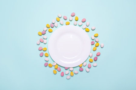 Easter blue background with eggs, plate. White plate for Easter treat. Mock up. Option of serving...