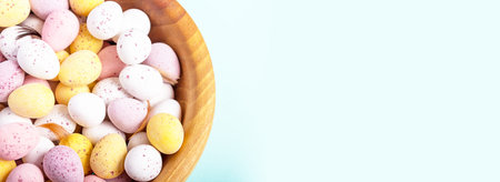 Easter banner. Easter eggs in wooden bowl on blue background. Selective focus with copy space....