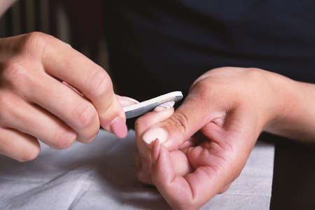 Shellac self removal at home. Nail polish removal with disposable nail file tools. Manicure at home. Step by step photo instruction. Step 1.の写真素材