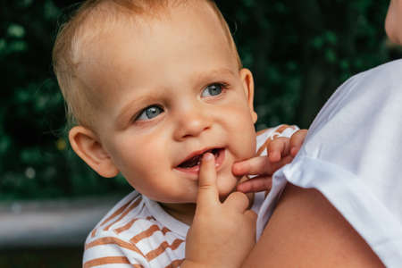 Little boy looks over his mothers shoulder.の写真素材
