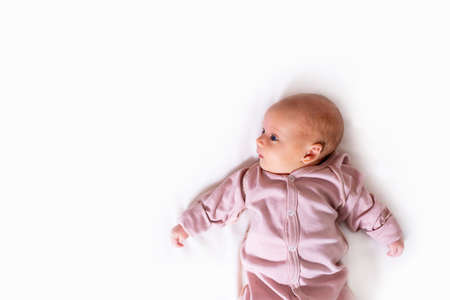 Newborn baby girl on white . Copy space.の写真素材