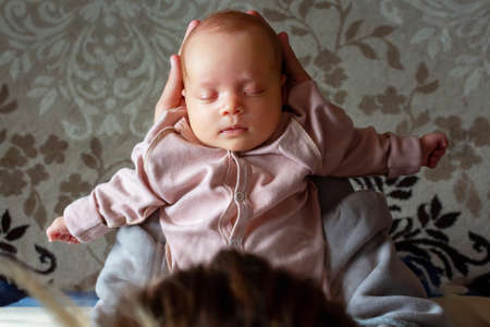 Mother holding baby in hands. Top view.