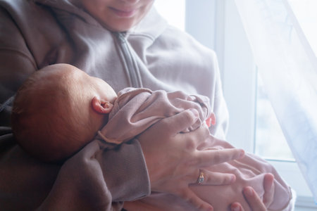 Mother holding baby in hands. Top view.の写真素材