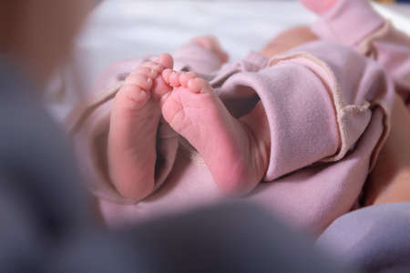 Newborn feets of caucasian newborn girl. Close-up.の写真素材