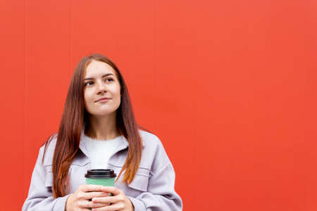 Young caucasian woman with glass of coffee.の写真素材