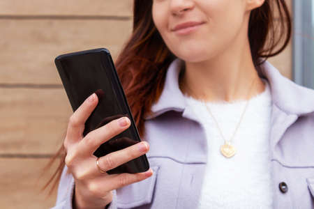 Woman holding mobile phone in hand.