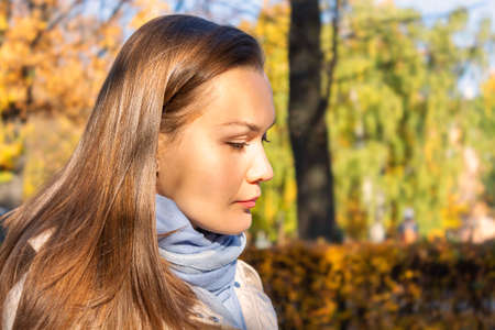 Beautiful happy woman walking in autumn park.