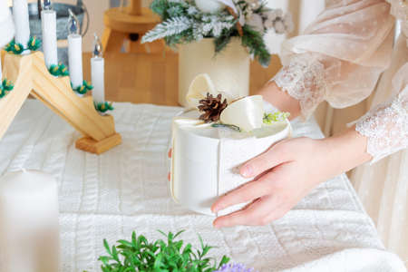 Hands in lace dress holding gift box.の写真素材