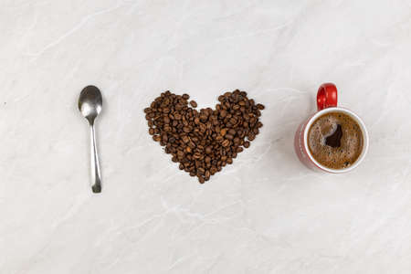 I love coffee with coffee beans in heart shape with cup of coffee.の写真素材
