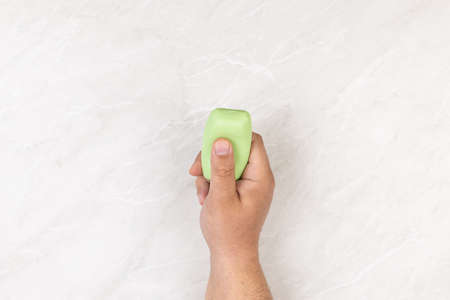 Hands holding soap showing washing hands as battle agains virus corona covid19.