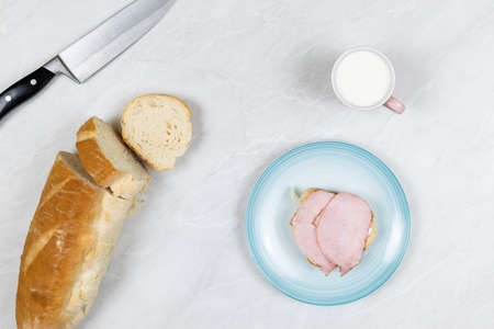 Flatlay above grey marble table with smoked ham sandwiches breakfast.の写真素材