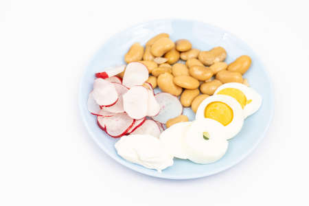 Salad with sliced boiled eggs, cooked beans, sliced radishes and sour cream.