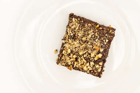 Chocolate Cake With Grated Nuts On The Plate Isolated Above White Background.の写真素材