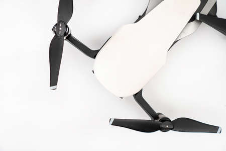 White drone quadcopter isolated above white background.