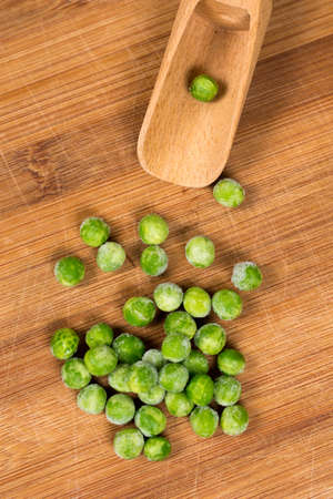 Green peas on the wooden board. Flat lay with copy space green peas.の写真素材