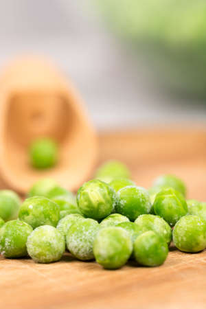 Frozen green peason the board with blurred background