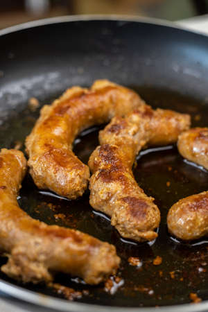 Fried Sausages in the frying pan with copy space on the grey marble table.の写真素材