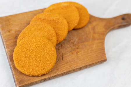 Round Fishcakes on the wooden board grey marble table.の写真素材
