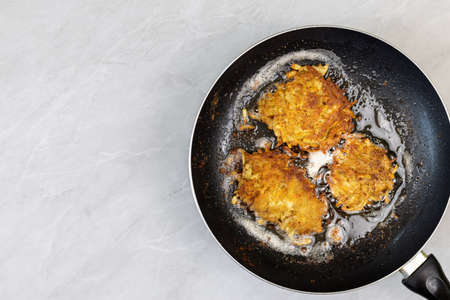 Frying grated potatoes pancakes in the frying pan.の写真素材